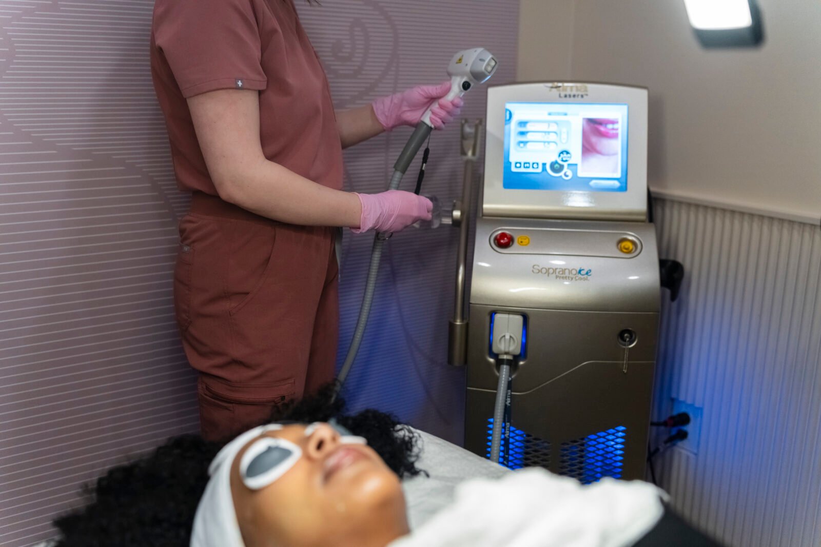Laser hair removal specialist operating treatment machine
